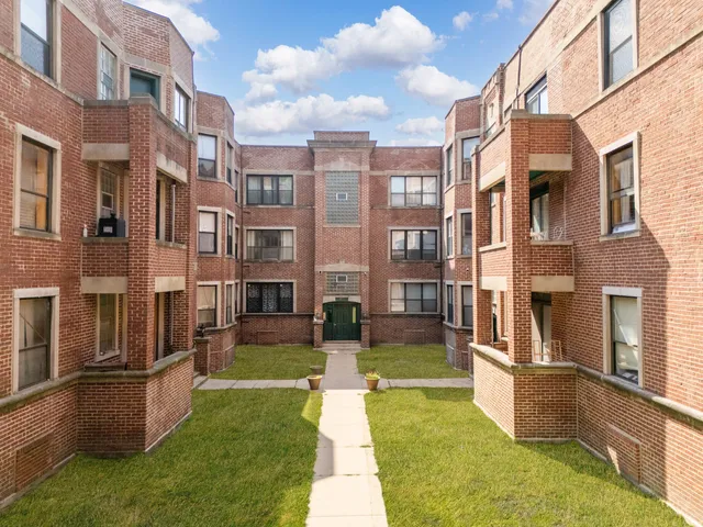 a view of a building with a yard