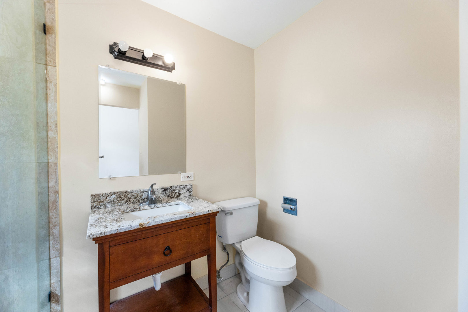 6104 South Dorchester Avenue, Unit 1S Chicago, IL 60637 - Photo 12 of 16 a bathroom with a granite countertop sink toilet and mirror