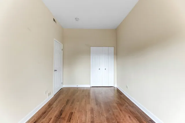 a view of a room with wooden floor