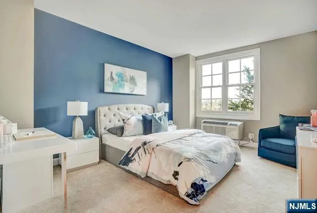 a bathroom with a granite countertop sink a mirror and a bathtub