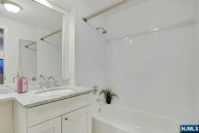 a kitchen with a sink wooden floor and stainless steel appliances