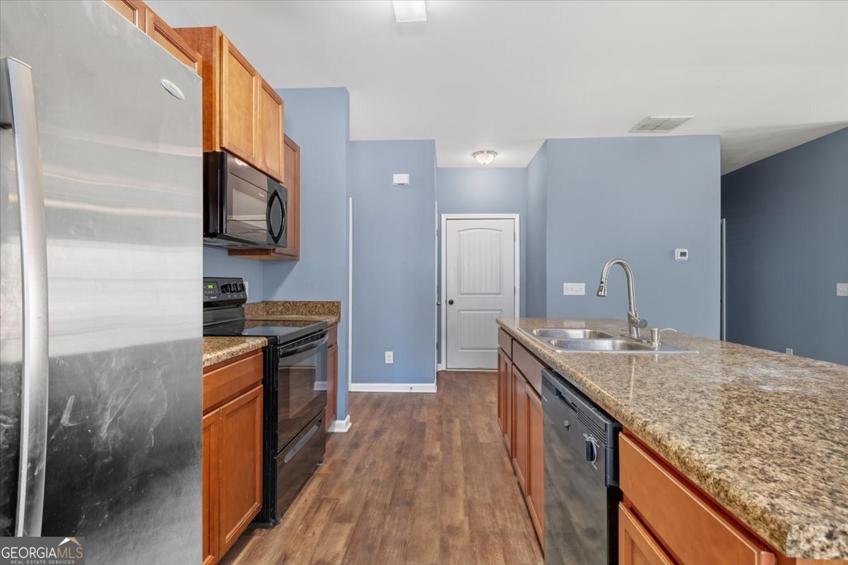 15 Grandberry Court Southwest Rome, GA 30165 - Photo 13 of 23 a kitchen with stainless steel appliances granite countertop a sink stove and refrigerator