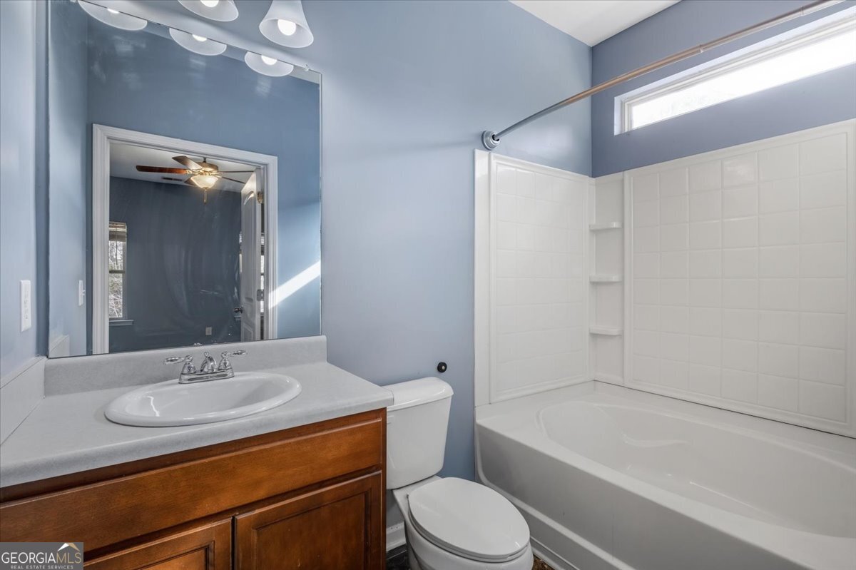 15 Grandberry Court Southwest Rome, GA 30165 - Photo 20 of 23 a bathroom with a granite countertop sink toilet mirror and bathtub