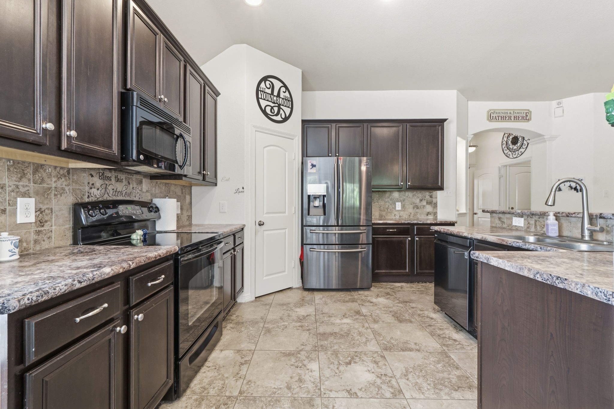 10802 Windswept Montgomery, TX 77356 - Photo 28 of 42 a kitchen with stainless steel appliances granite countertop a stove refrigerator sink and microwave