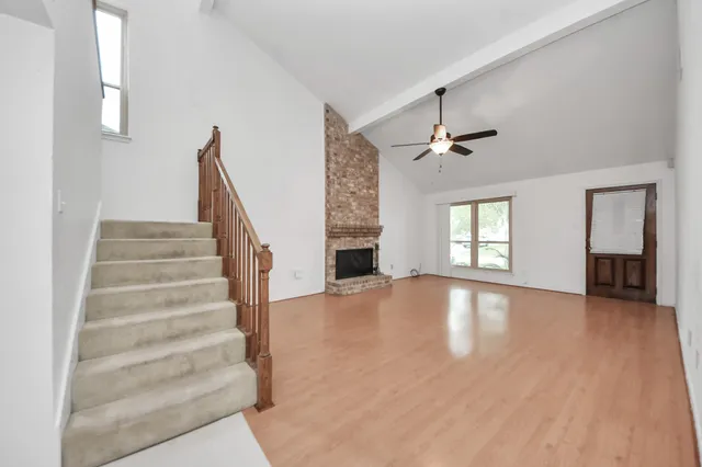 a kitchen with granite countertop a sink stove and cabinets