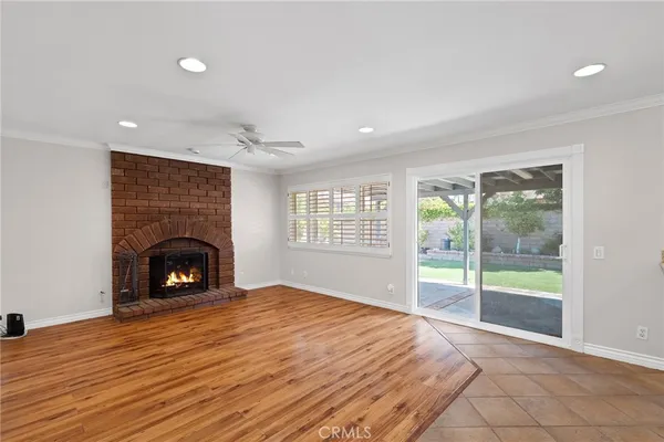 a view of a livingroom with a fireplace and window