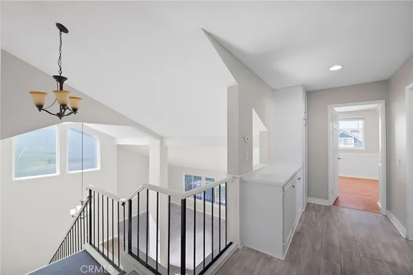 a view of hallway with stairs and wooden floor
