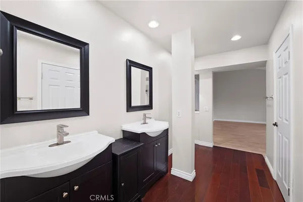 a bathroom with a double vanity sink and a mirror