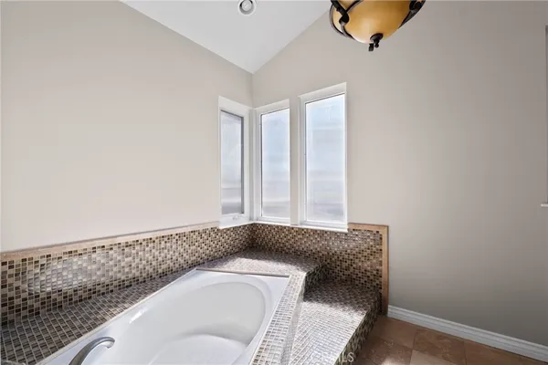 a bathroom with a granite countertop sink and a vanity