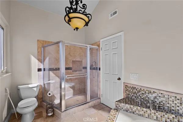 a bathroom with a shower a toilet and a sink