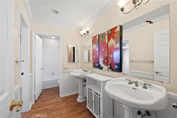 a bathroom with a double vanity sink a mirror and a shower