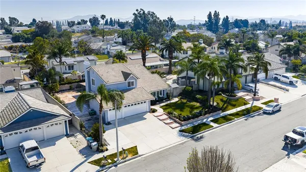 an aerial view of multiple houses with yard