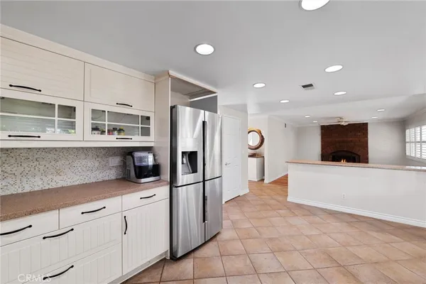 a kitchen with stainless steel appliances a refrigerator and a stove top oven