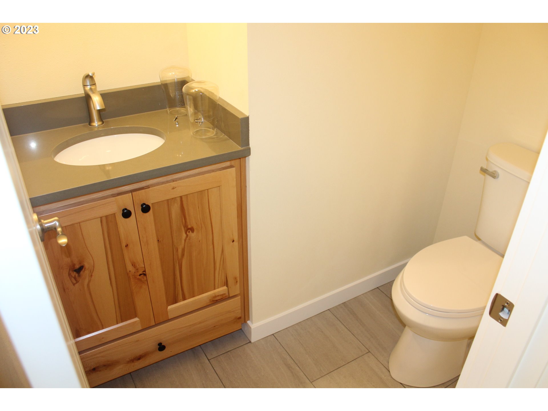 1384 10th Seaside, OR 97138 - Photo 11 of 36 a bathroom with a sink a toilet and vanity