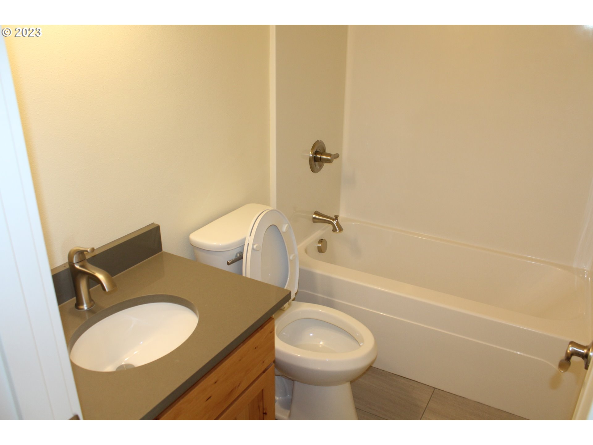 1384 10th Seaside, OR 97138 - Photo 23 of 36 a bathroom with a granite countertop toilet and sink