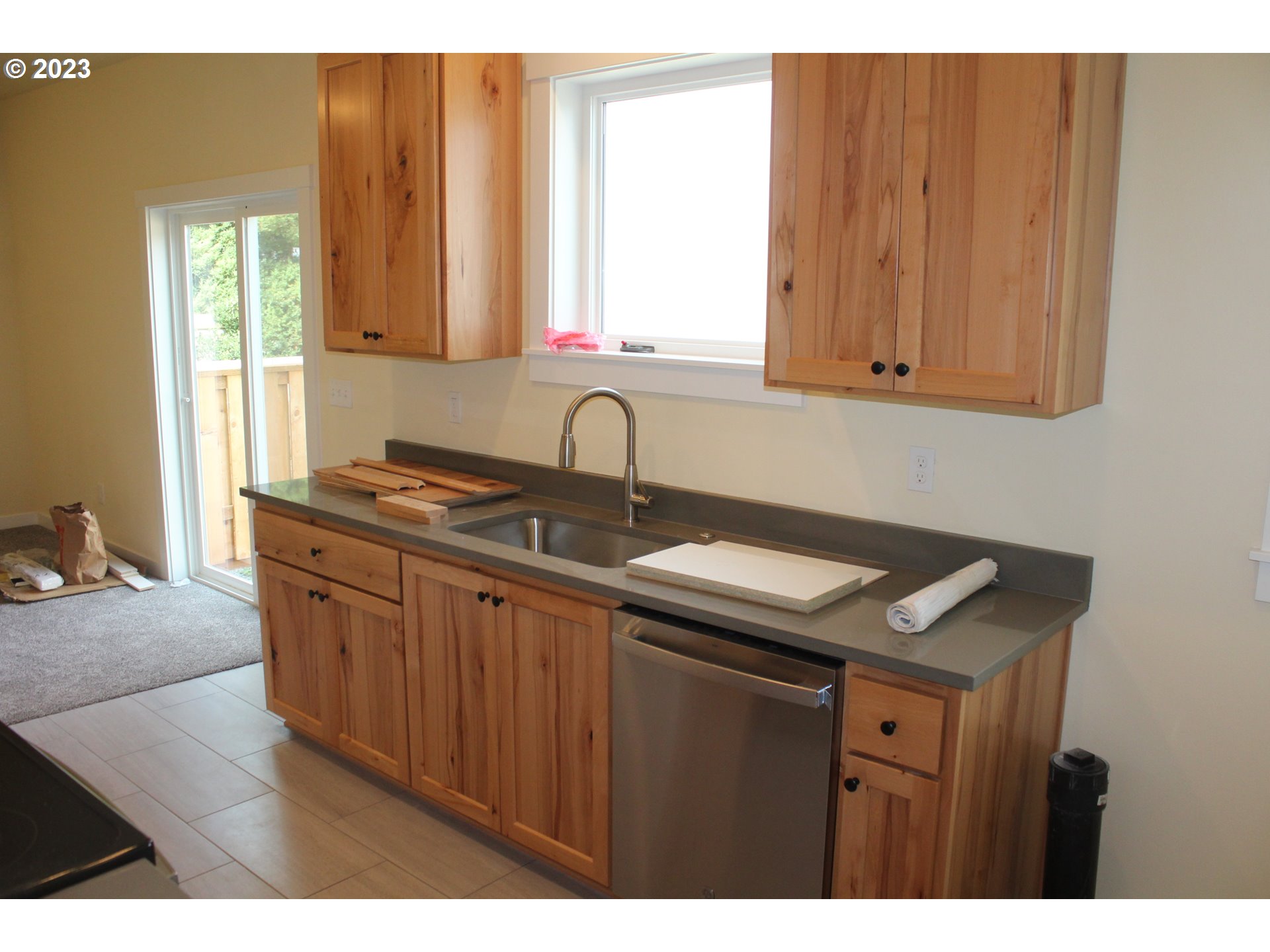 1384 10th Seaside, OR 97138 - Photo 9 of 36 a kitchen with stainless steel appliances granite countertop a sink stove and cabinets