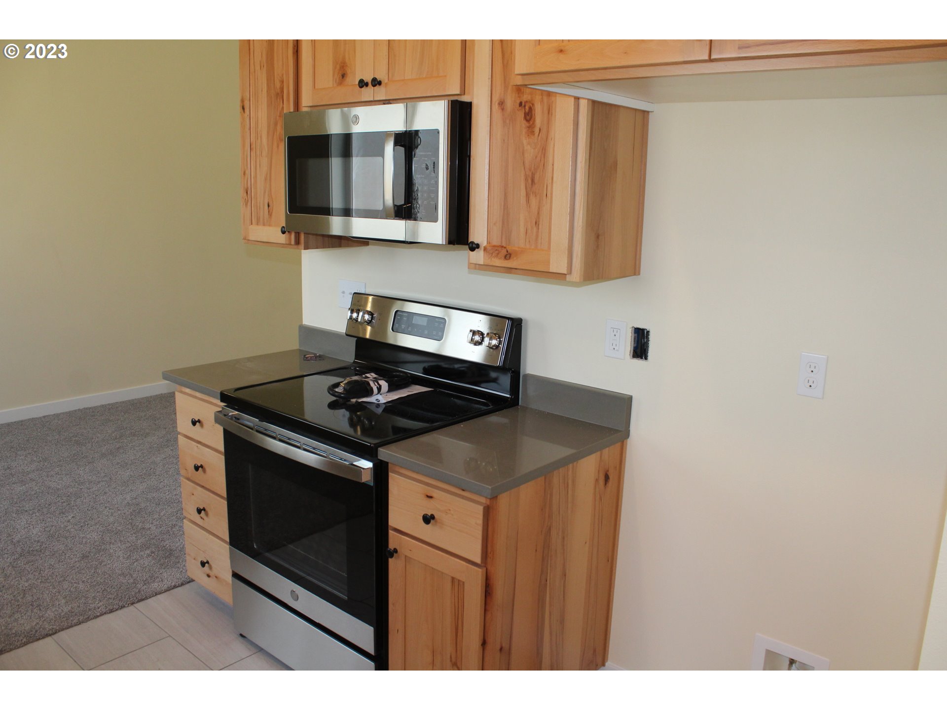 1384 10th Seaside, OR 97138 - Photo 10 of 36 a kitchen with stainless steel appliances granite countertop a stove microwave and sink