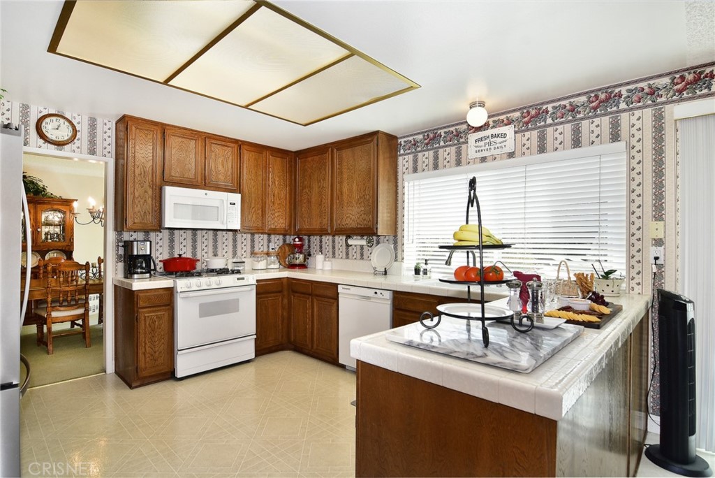 23628 Spires Street West Hills, CA 91304 - Photo 12 of 36 a kitchen with a stove a sink and a refrigerator