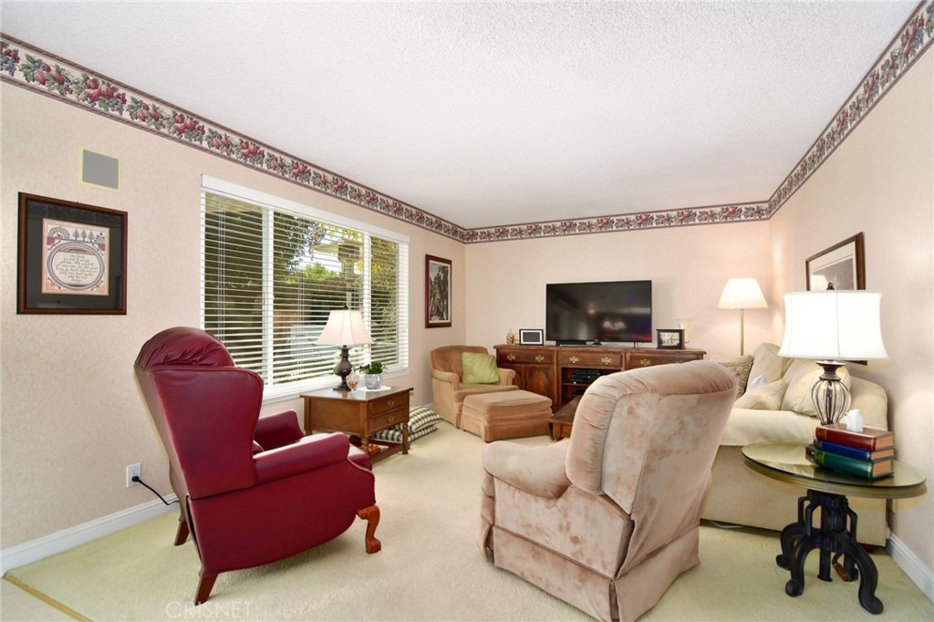 23628 Spires Street West Hills, CA 91304 - Photo 15 of 36 a living room with furniture a flat screen tv and a large window