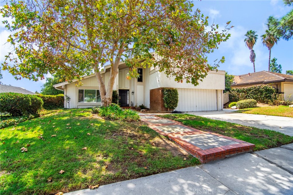 23628 Spires Street West Hills, CA 91304 - Photo 2 of 36 a front view of a house with garden