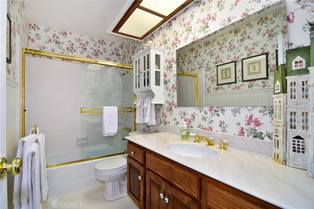 23628 Spires Street West Hills, CA 91304 - Photo 22 of 36 a bathroom with a sink mirror vanity and toilet