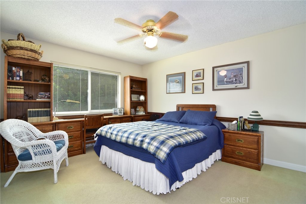 23628 Spires Street West Hills, CA 91304 - Photo 23 of 36 a bedroom with a bed and a couch