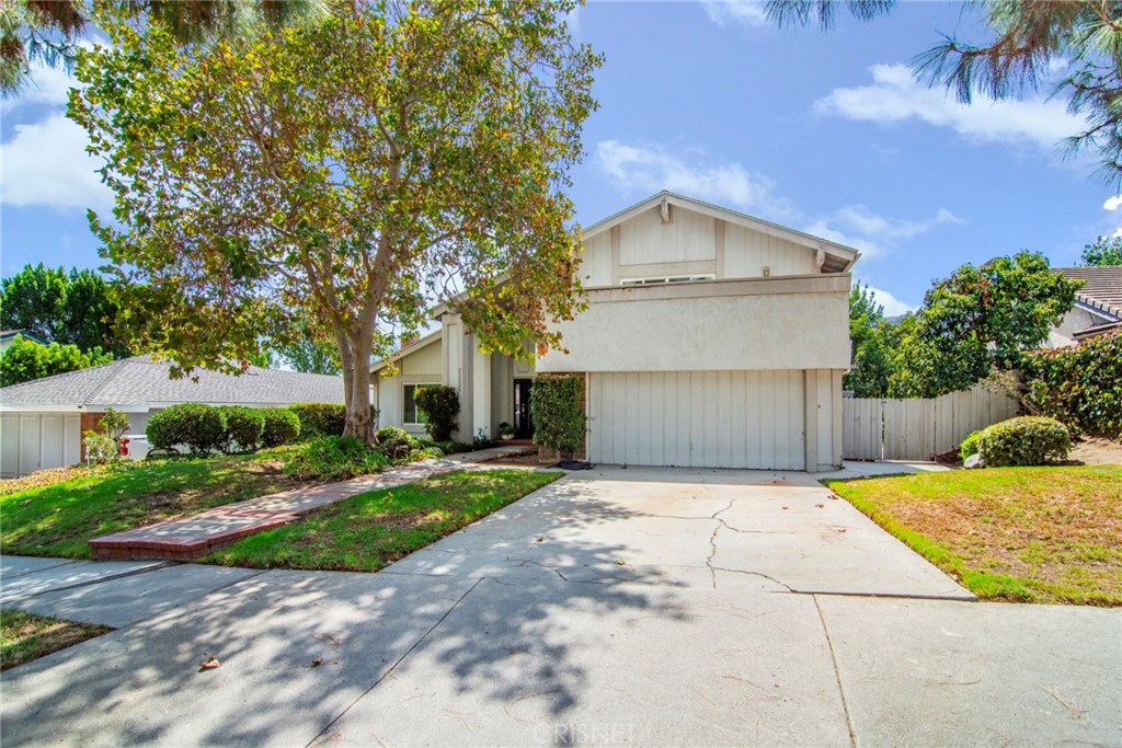 23628 Spires Street West Hills, CA 91304 - Photo 3 of 36 a front view of a house with a yard and garage