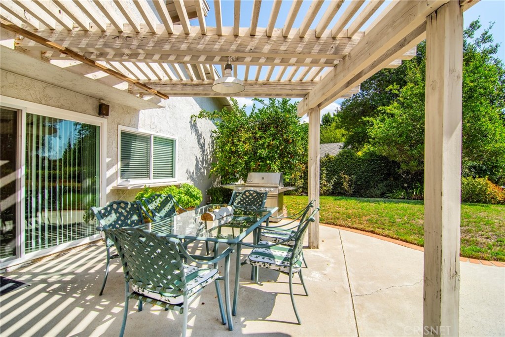 23628 Spires Street West Hills, CA 91304 - Photo 35 of 36 a view of a patio with table and chairs potted plants with floor to ceiling window