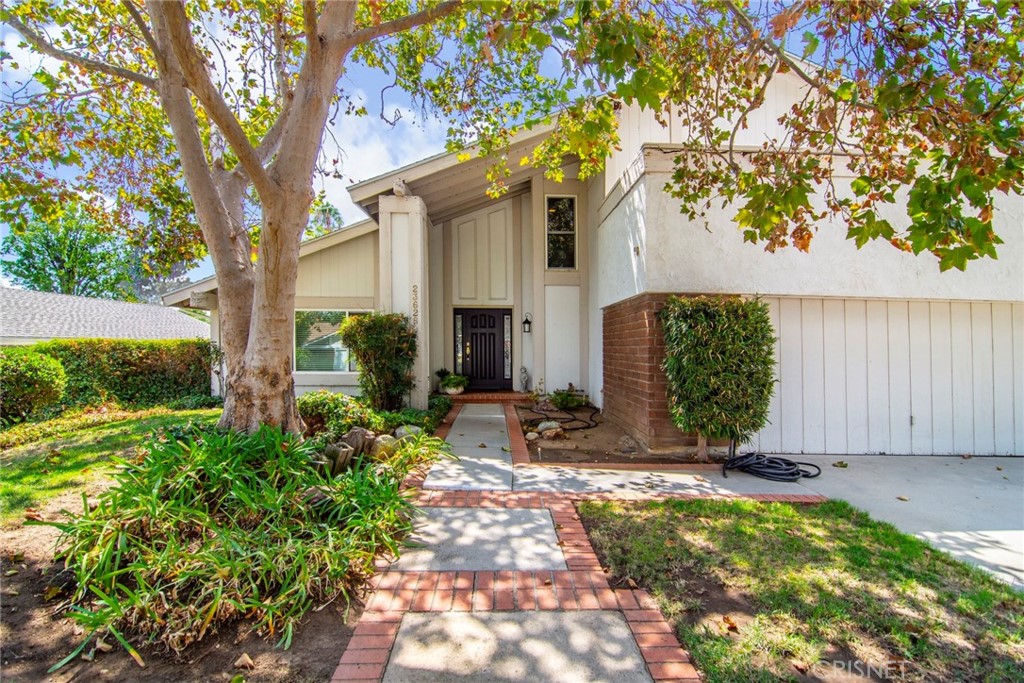 23628 Spires Street West Hills, CA 91304 - Photo 4 of 36 a front view of a house with garden