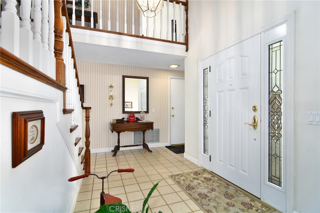 23628 Spires Street West Hills, CA 91304 - Photo 5 of 36 a view of a hallway with wooden floor and staircase