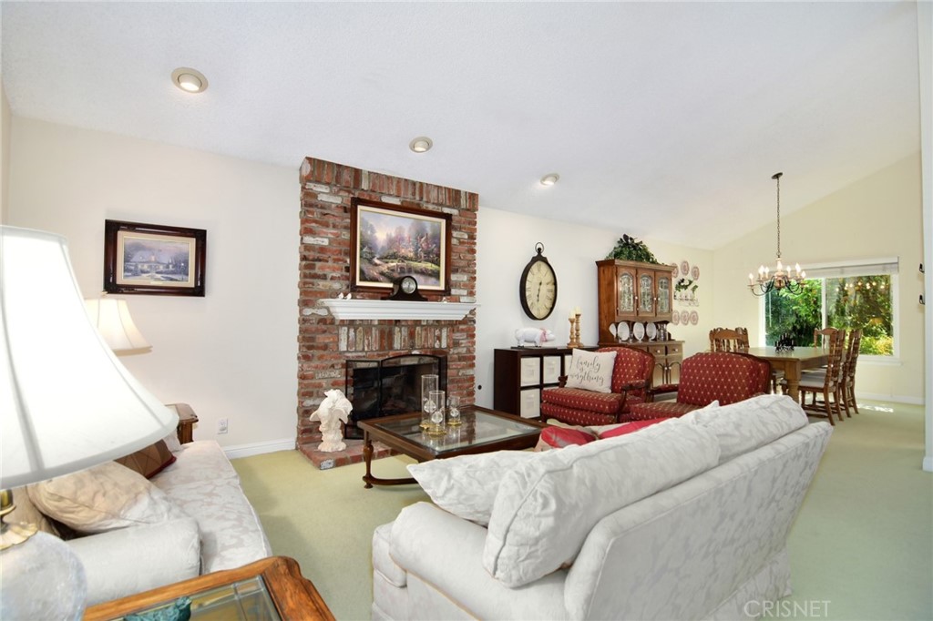 23628 Spires Street West Hills, CA 91304 - Photo 7 of 36 a living room with furniture a fireplace and a flat screen tv