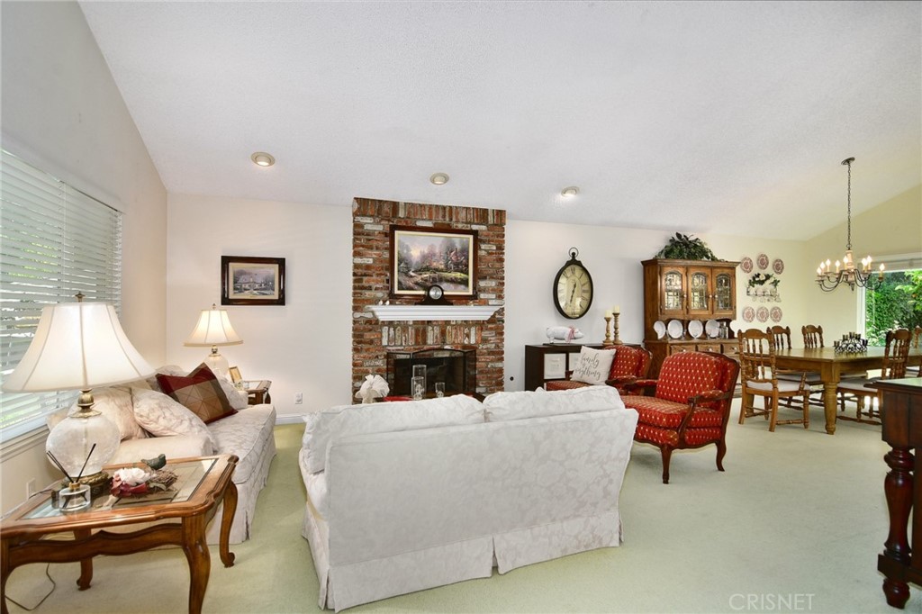 23628 Spires Street West Hills, CA 91304 - Photo 8 of 36 a living room with furniture chandelier and a fireplace