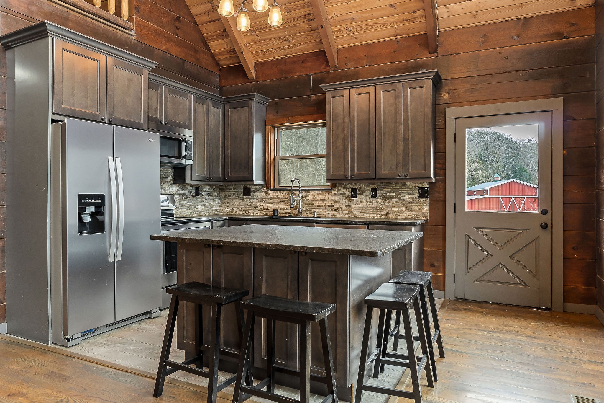 4830 Ensor Hollow Road Granville, TN 38564 - Photo 36 of 54 a kitchen with stainless steel appliances kitchen island granite countertop a refrigerator and a stove top oven