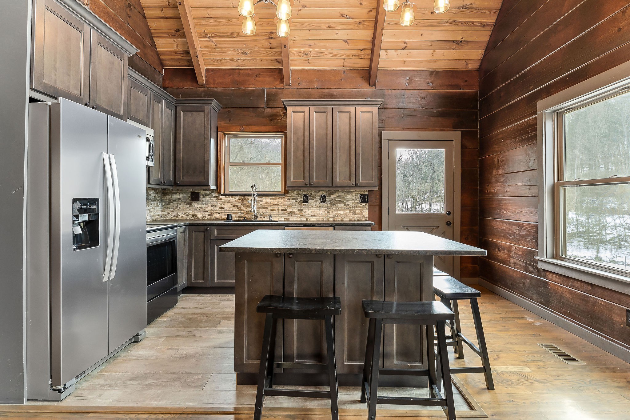 4830 Ensor Hollow Road Granville, TN 38564 - Photo 37 of 54 a kitchen with a table chairs refrigerator and cabinets