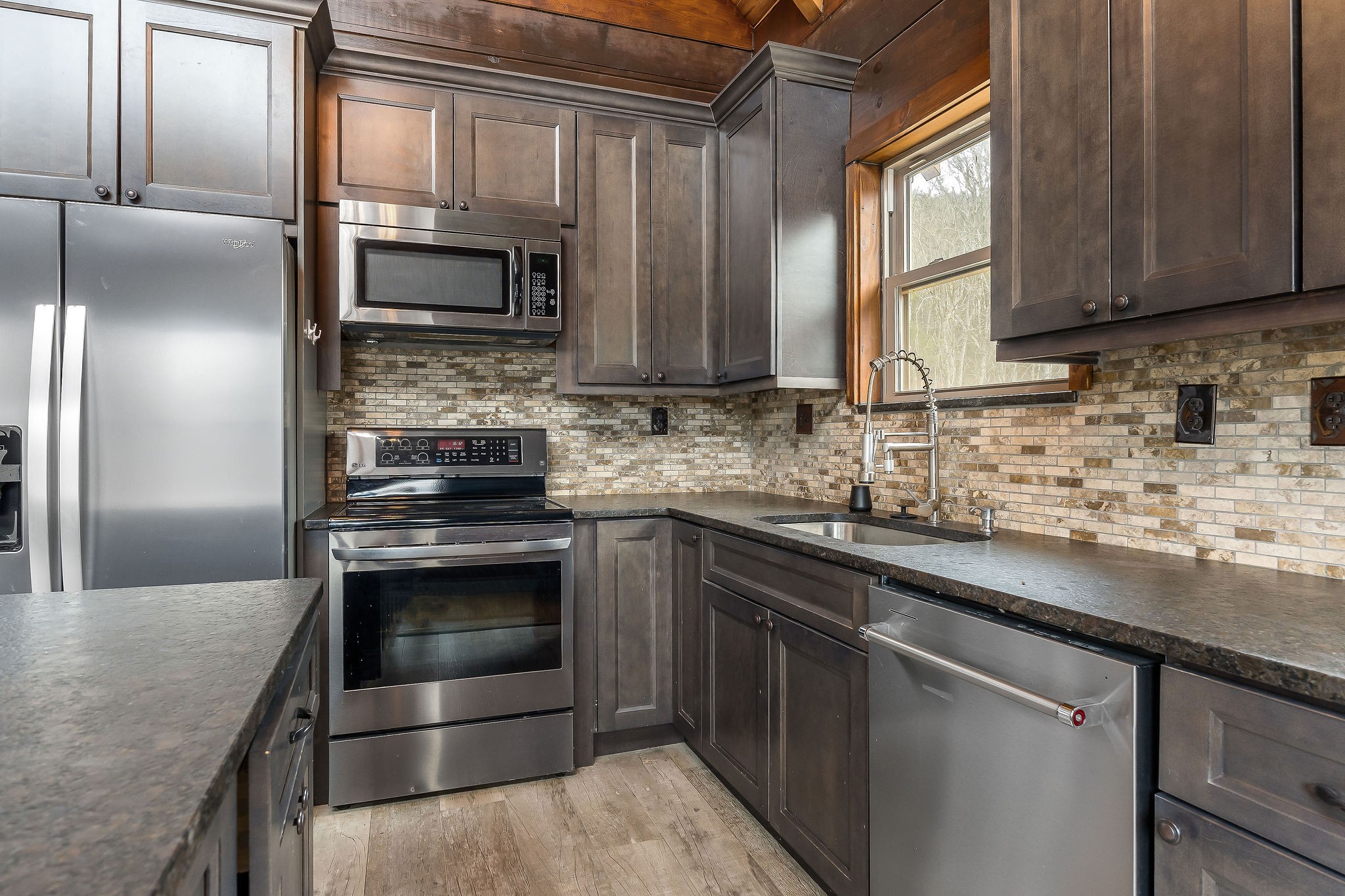 4830 Ensor Hollow Road Granville, TN 38564 - Photo 38 of 54 a kitchen with stainless steel appliances granite countertop a sink stove and refrigerator