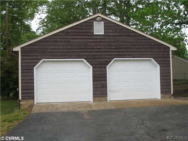11612 Genito Road Midlothian, VA 23112 - Photo 2 of 12 a front view of a house with garage