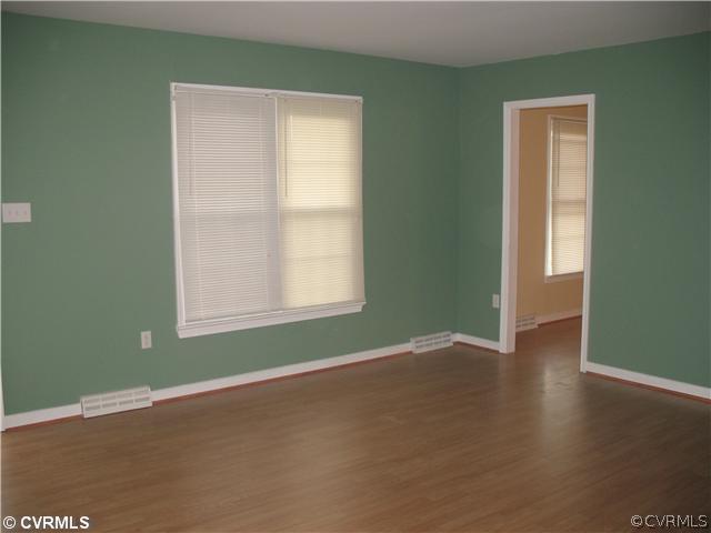 11612 Genito Road Midlothian, VA 23112 - Photo 6 of 12 an empty room with wooden floor and windows