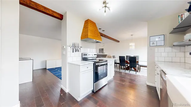 a kitchen with a sink cabinets and wooden floor