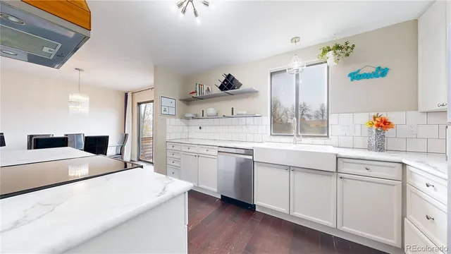 a kitchen with a sink a stove and cabinets