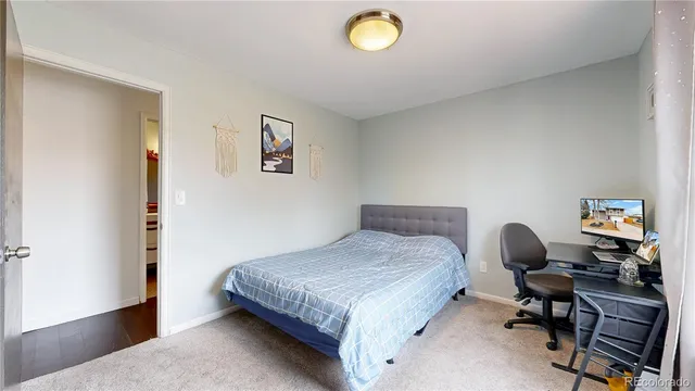 a bedroom with a bed and a chair