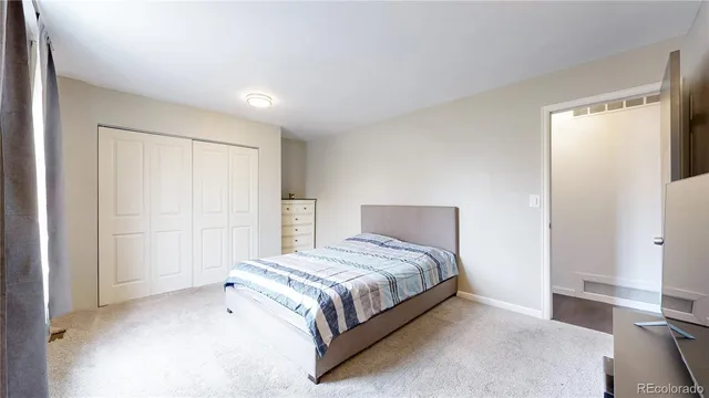 a bedroom with a bed and a night stand