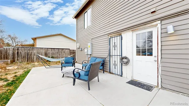 a view of a patio with a table and chairs