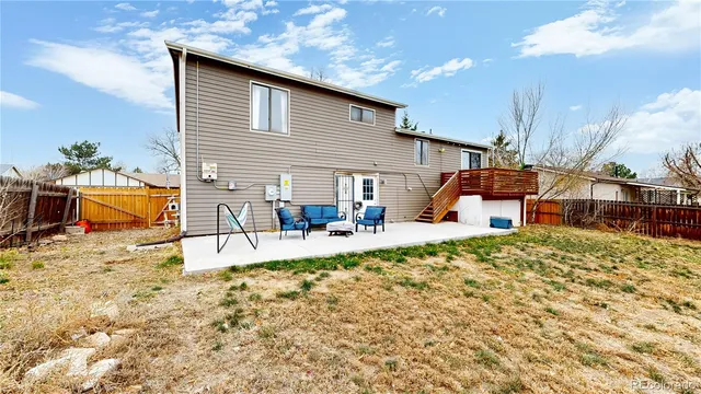 a view of a house with backyard and sitting area