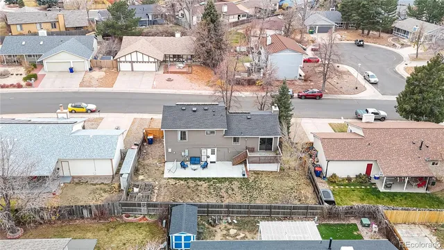 an aerial view of residential houses with outdoor space and swimming pool