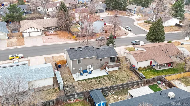 an aerial view of a house with table and chairs