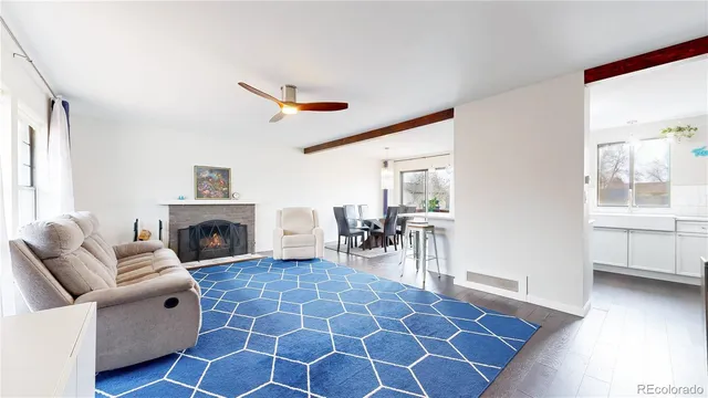 a living room with furniture a fireplace and a table