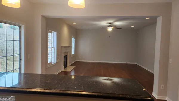 a view of a hallway with wooden floor
