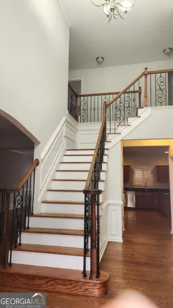 a view of entryway and hall with wooden floor