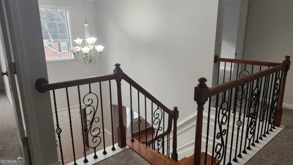 a view of staircase with wooden floor and stairs