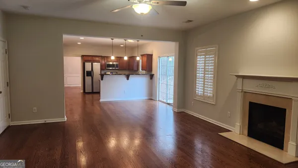 a view of a livingroom with a kitchen and a fireplace